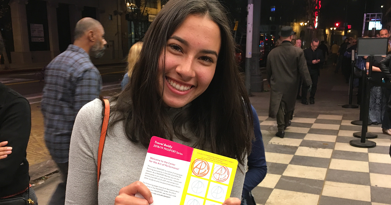 Girl holding a CAP UCLA Passport