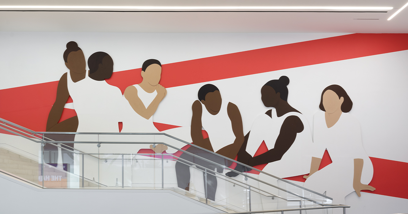 Image of Hammer Museum installation, featuring lobby of museum with mural of people in white sitting on a red painted line