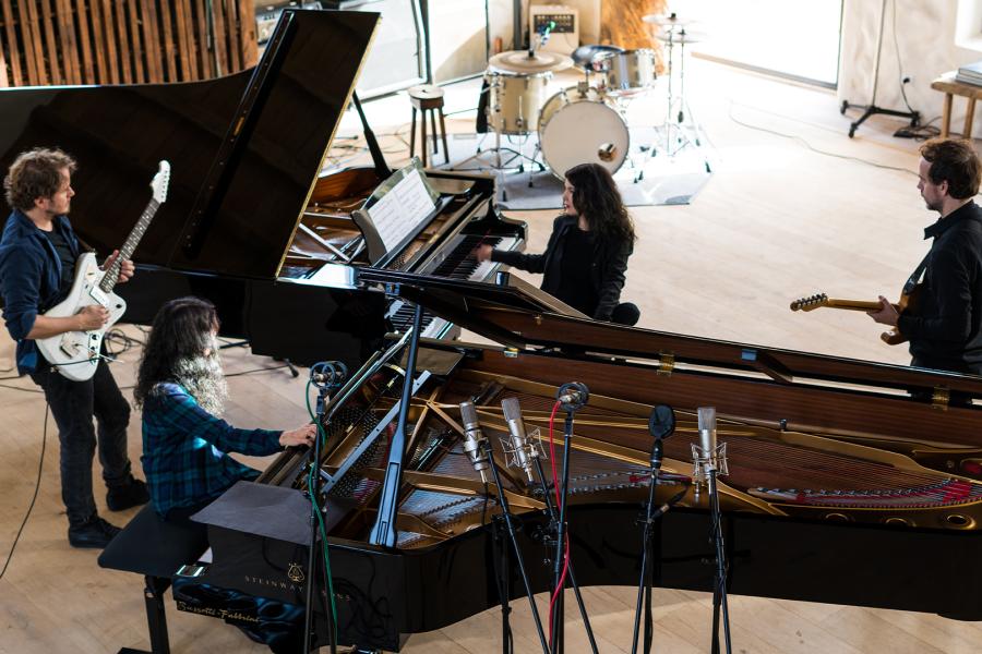 Dream House Quartet rehearses around a piano in 900x600