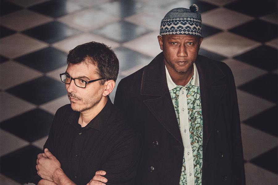 Ablaye Cissoko & Cyrille Brotto stand on a checkered floor