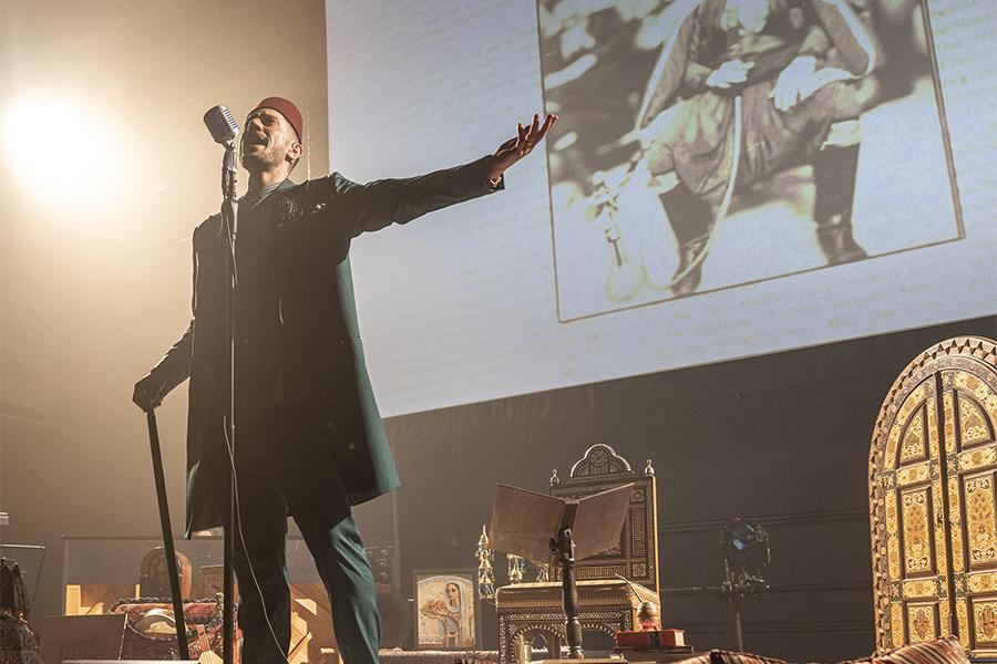 Omar Offendum performs on stage