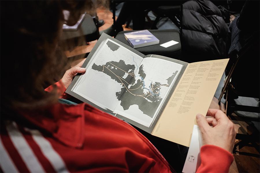 Image of person holding copy of the book 'Borderline Visible.'