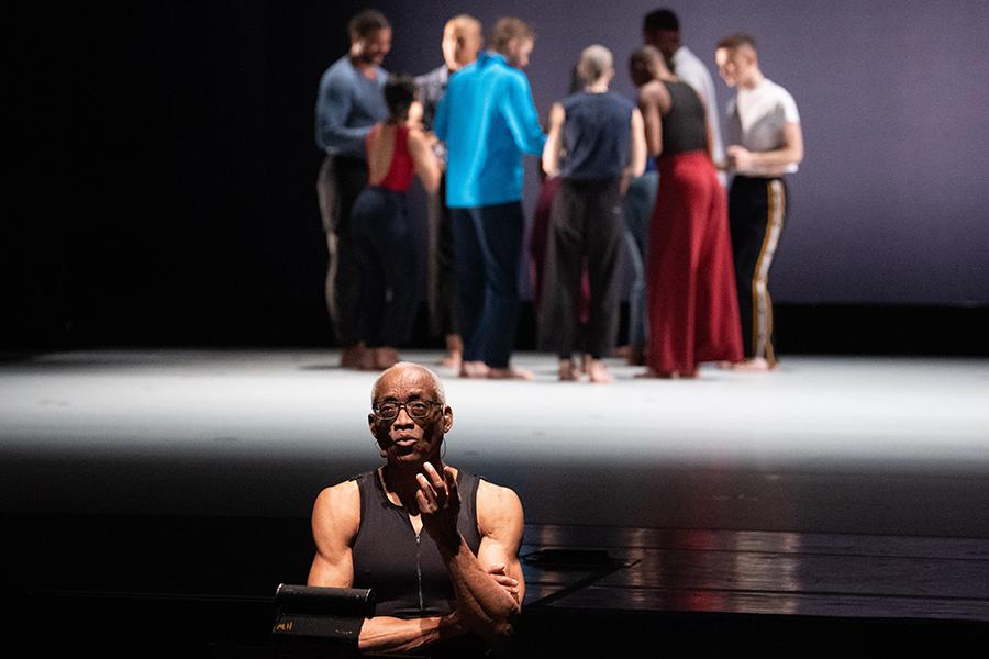 Bill T. Jones speaking with dancers in the background